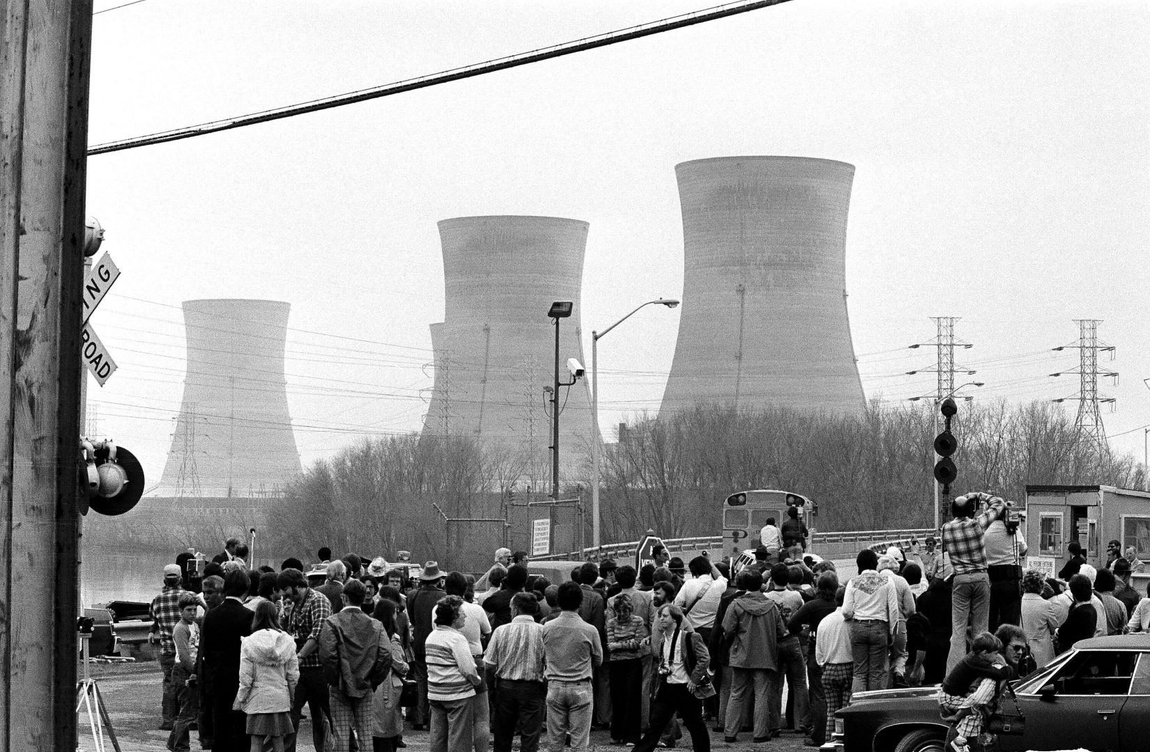 People stand in the foreground of Three Mile Island